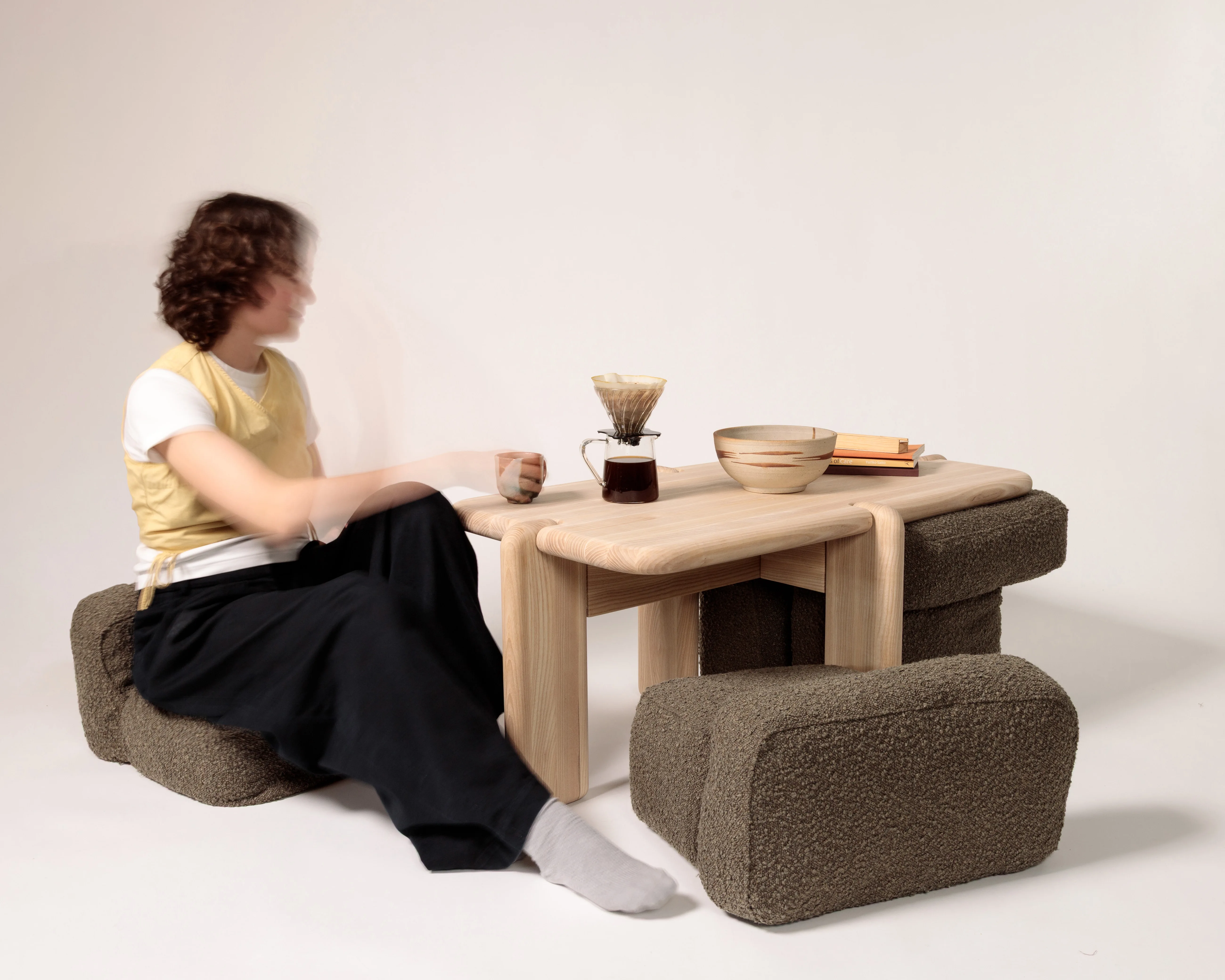 Kin, a low table with cushions that tuck beneath it.